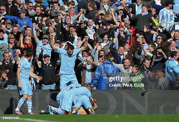 Manchester City's Argentinian striker Sergio Aguero celebrates his late winning goal with team-mates during the English Premier League football match...