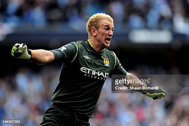Goalkeeper Joe Hart of Manchester City celebrates winning the title as the final whistle blows during the Barclays Premier League match between...