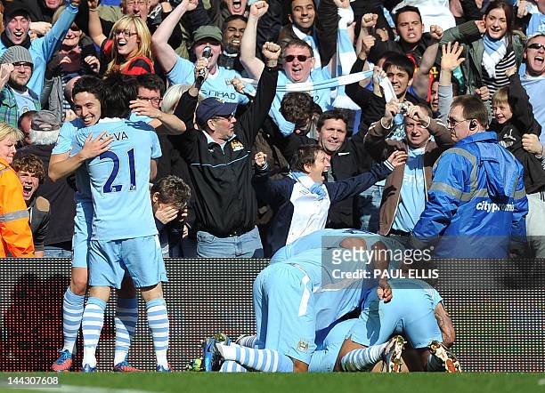 Manchester City's Argentinian striker Sergio Aguero celebrates his late winning goal with team-mates during the English Premier League football match...