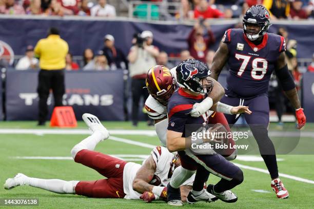 Davis Mills of the Houston Texans gets sacked by Jonathan Allen of the Washington Commanders in the third quarter at NRG Stadium on November 20, 2022...