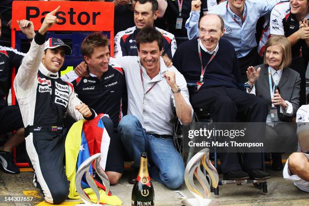 Pastor Maldonado of Venezuela and Williams celebrates with Team Principal Sir Frank Williams team mates in the pitlane after winning the Spanish...