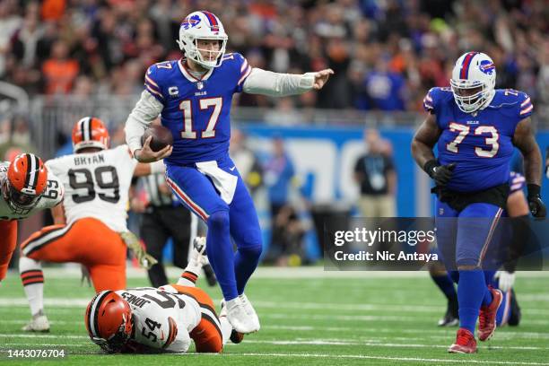 Josh Allen of the Buffalo Bills runs past Deion Jones of the Cleveland Browns during the third quarter at Ford Field on November 20, 2022 in Detroit,...
