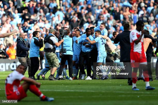 Manchester City players celebrate winning the title as the final whistle blows during the Barclays Premier League match between Manchester City and...