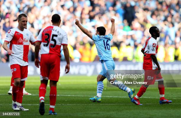 Sergio Aguero of Manchester City celebrates winning the title as the final whistle blows during the Barclays Premier League match between Manchester...