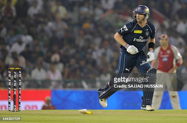 Deccan Chargers batsman Cameron White runs between the wicket after losing grip of his bat during the IPL Twenty20 cricket match between Kings XI...
