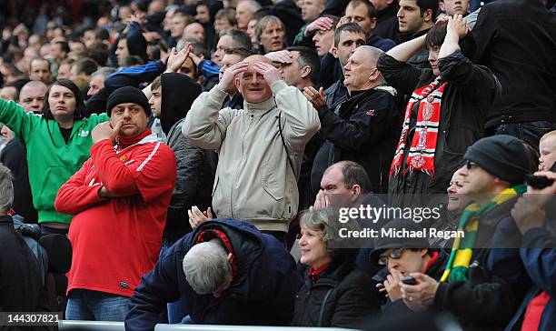 Manchester United fans react to news from Manchester City during the Barclays Premier League match between Sunderland and Manchester United at the...