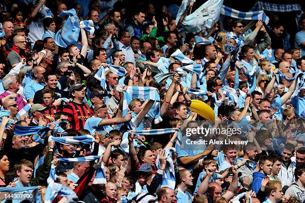 Manchester City fans cheer on their team during the Barclays Premier League match between Manchester City and Queens Park Rangers at the Etihad...