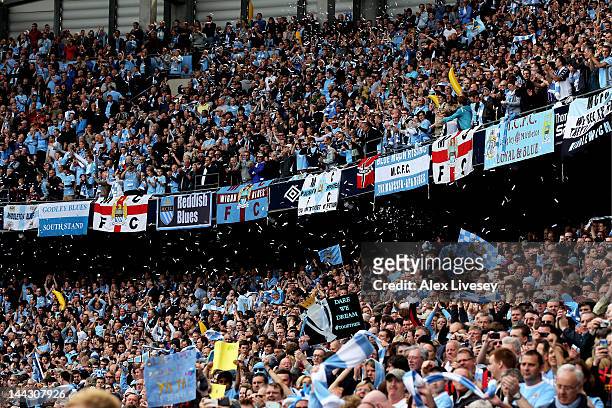 Manchester City fans cheer on their team during the Barclays Premier League match between Manchester City and Queens Park Rangers at the Etihad...