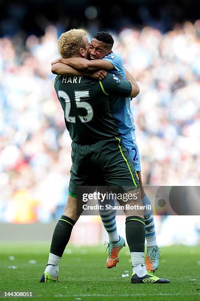 Goalkeeper Joe Hart and Gael Clichy of Manchester City celebrate winning the title as the final whistle blows during the Barclays Premier League...