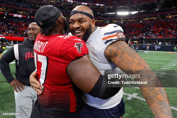 Grady Jarrett of the Atlanta Falcons and Mike Pennel Jr. #64 of the Chicago Bears hug after Atlanta's 27-24 win at Mercedes-Benz Stadium on November...