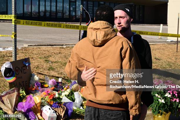 Tyler Johnston, right, comforts his friend Joshua Thurman at a makeshift memorial near Club Q on November 20, 2022 in Colorado Springs, Colorado....
