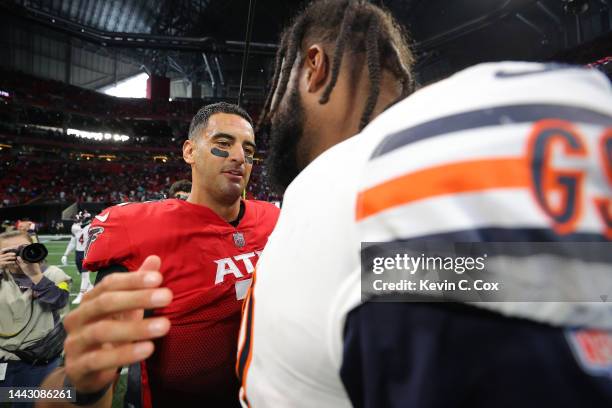 Marcus Mariota of the Atlanta Falcons and Angelo Blackson of the Chicago Bears hug after Atlanta's 27-24 win at Mercedes-Benz Stadium on November 20,...