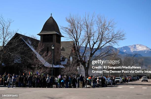 People gather outside All Souls Unitarian Church for a vigil for the victims of an overnight shooting at Club Q, an LGBTQ nightclub, on Nov. 20 in...