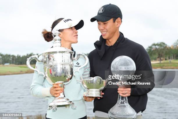 Lydia Ko of New Zealand poses for a photo with her fiancé, the Vare Trophy, the Rolex Player of the Year trophy and the CME Globe trophy after...
