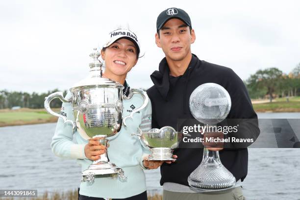 Lydia Ko of New Zealand poses for a photo with her fiancé, the Vare Trophy, the Rolex Player of the Year trophy and the CME Globe trophy after...