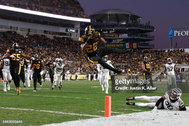 Najee Harris of the Pittsburgh Steelers hurdles Jessie Bates III of the Cincinnati Bengals while scoring a touchdown during the second quarter at...