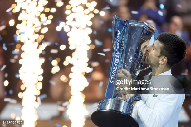 Novak Djokovic of Serbia celebrates with the trophy after defeating Casper Ruud of Norway during the Final on Day Eight of the Nitto ATP Finals at...