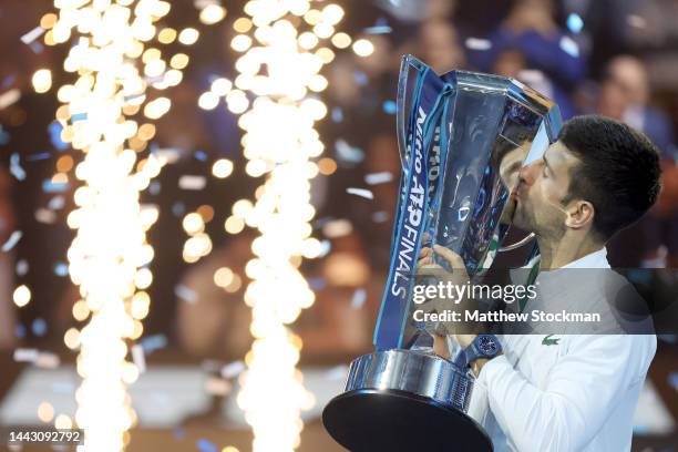 Novak Djokovic of Serbia celebrates with the trophy after defeating Casper Ruud of Norway during the Final on Day Eight of the Nitto ATP Finals at...