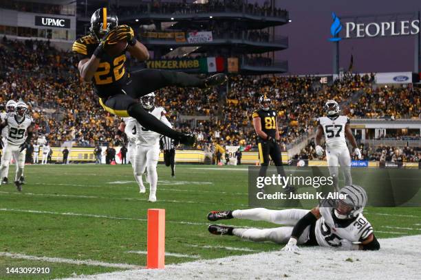 Najee Harris of the Pittsburgh Steelers hurdles Jessie Bates III of the Cincinnati Bengals while scoring a touchdown during the second quarter at...