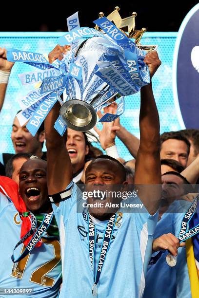 Vincent Kompany the captain of Manchester City lifts the trophy following the Barclays Premier League match between Manchester City and Queens Park...