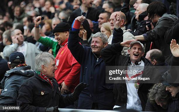 Manchester United fans celebrate hearing news of a goal by QPR at Manchester City during the Barclays Premier League match between Sunderland and...