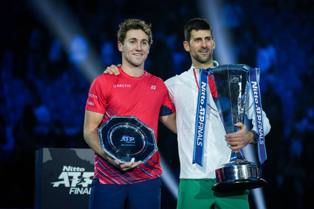 Novak Djokovic of Serbia and Casper Ruud of Norway pose with their trophies on the podium after the Final Single match during day eight of the Nitto...