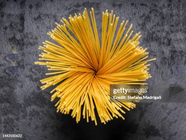 raw pasta, spaghetti black background - dry pasta stock pictures, royalty-free photos & images