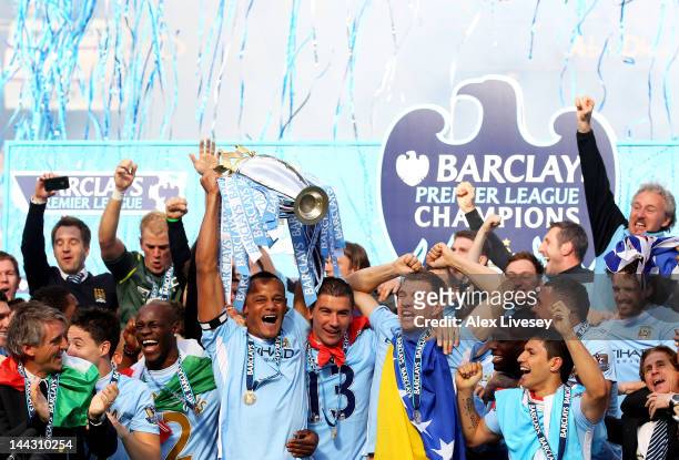 Vincent Kompany the captain of Manchester City lifts the trophy following the Barclays Premier League match between Manchester City and Queens Park...