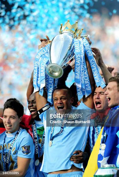 Vincent Kompany the captain of Manchester City lifts the trophy following the Barclays Premier League match between Manchester City and Queens Park...