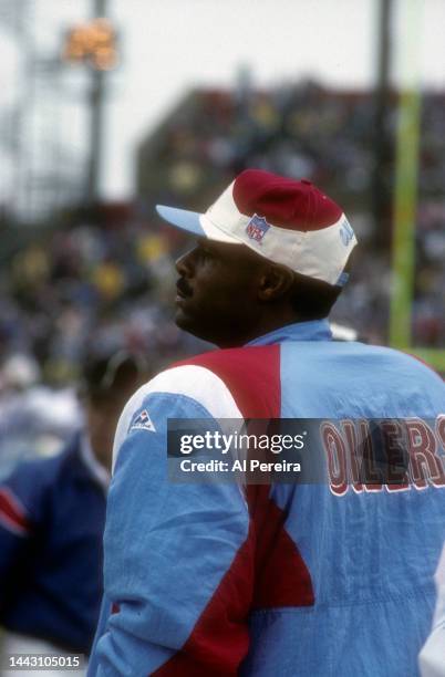 Quarterback Warren Moon of the Houston Oilers follows the action in the game between the Houston Oilers vs the New England Patriots at Foxboro...