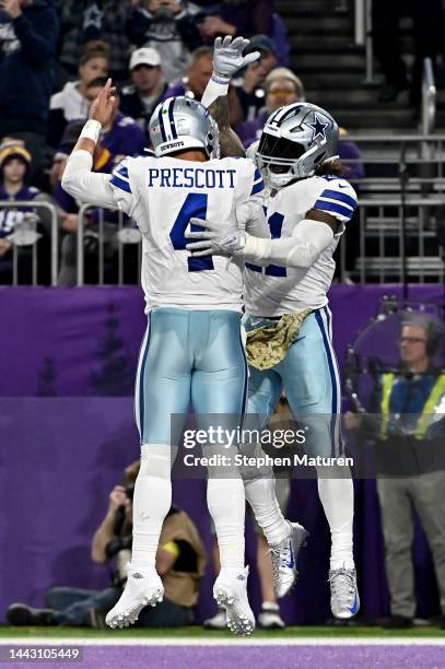 Ezekiel Elliott of the Dallas Cowboys celebrates his touchdown against the Minnesota Vikings during the third quarter with teammate Dak Prescott at...