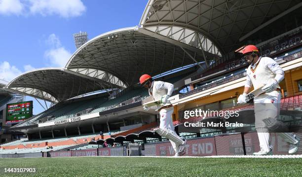 Harry Nielsen of the Redbacks and Ben Manenti of the Redbacks head out to batduring the Sheffield Shield match between South Australia Redbacks and...