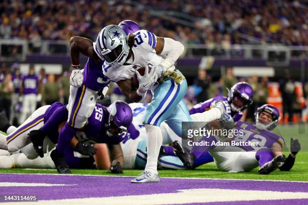 Ezekiel Elliott of the Dallas Cowboys rushes for a touchdown against the Minnesota Vikings during the third quarter at U.S. Bank Stadium on November...