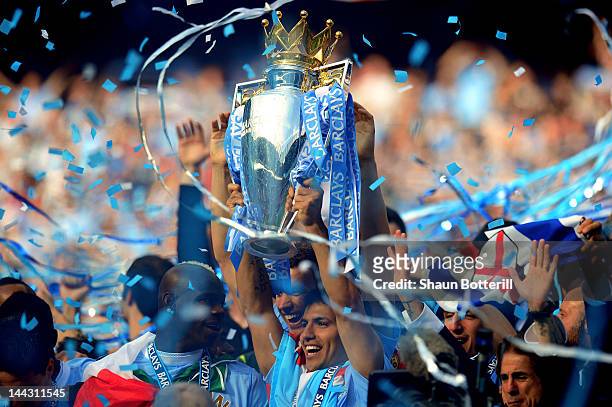 Scorer of the matchwinning goal Sergio Aguero of Manchester City celebrates with the trophy during the Barclays Premier League match between...