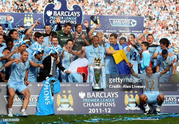 The Manchester City players celebrate with the trophy following the Barclays Premier League match between Manchester City and Queens Park Rangers at...
