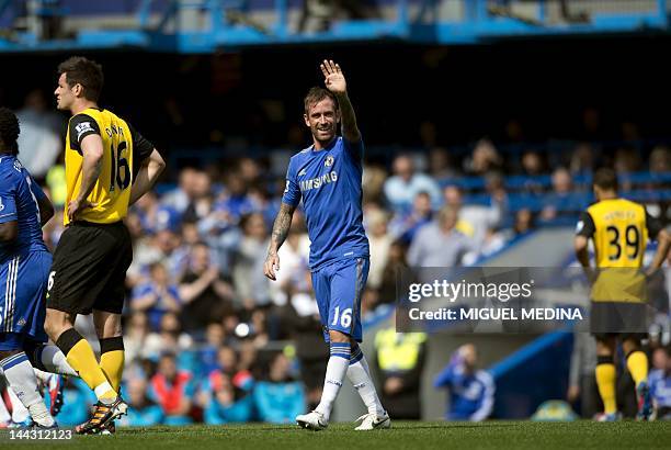 Chelsea's Portuguese midfielder Raul Meireles waves after scoring against during the English Premier League football match between Chelsea and...