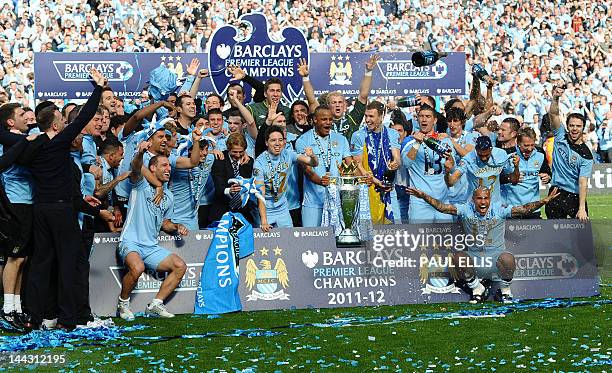 Manchester City players celebrate with the Premier League trophy after their 3-2 victory over Queens Park Rangers in the English Premier League...