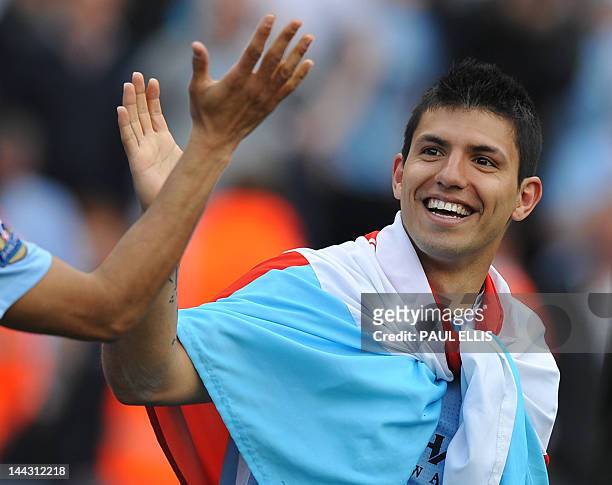 Manchester City's Argentinian striker Sergio Aguero celebrates on the pitch after their 3-2 victory over Queens Park Rangers in the English Premier...
