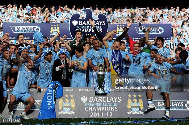 The Manchester City players celebrate with the trophy following the Barclays Premier League match between Manchester City and Queens Park Rangers at...