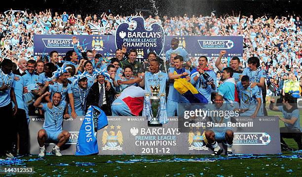 The Manchester City players celebrate with the trophy following the Barclays Premier League match between Manchester City and Queens Park Rangers at...