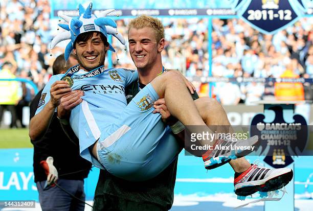 Teammates David Silva and Joe Hart of Manchester City celebrate following the Barclays Premier League match between Manchester City and Queens Park...