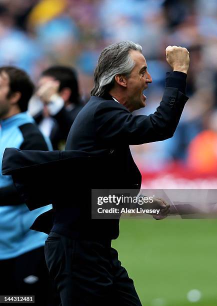 Roberto Mancini the manager of Manchester City celebrates the matchwinning goal during the Barclays Premier League match between Manchester City and...