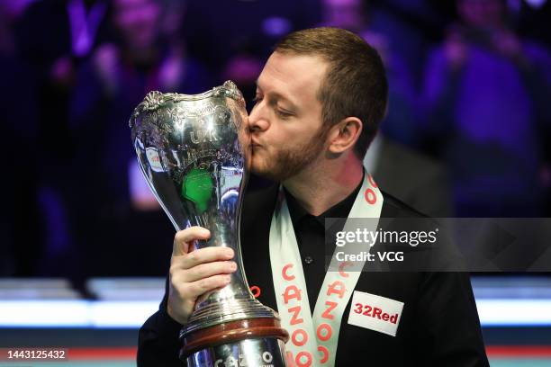 Mark Allen of Northern Ireland celebrates with the trophy after winning the final match against Ding Junhui of China on day 9 of 2022 Cazoo UK...