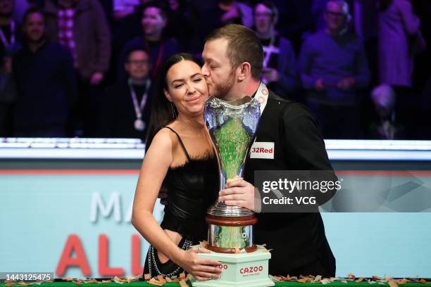 Mark Allen of Northern Ireland celebrates with the trophy after winning the final match against Ding Junhui of China on day 9 of 2022 Cazoo UK...