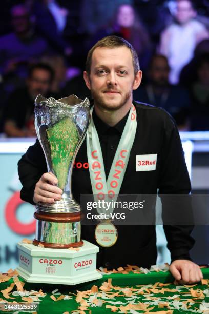 Mark Allen of Northern Ireland celebrates with the trophy after winning the final match against Ding Junhui of China on day 9 of 2022 Cazoo UK...