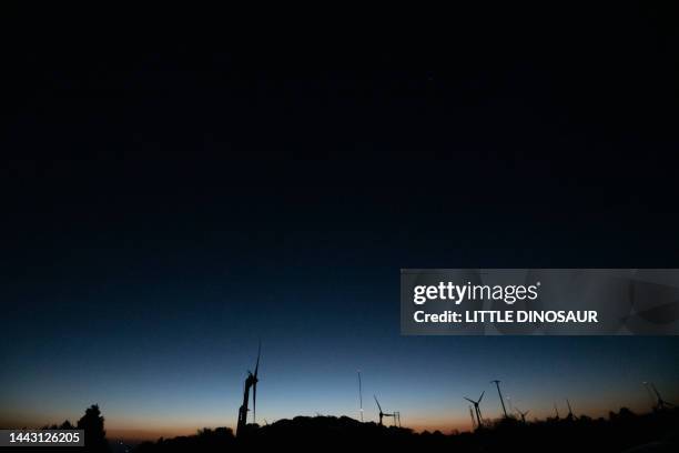 silhouette of wind generators at twilight - wind power japan stock pictures, royalty-free photos & images