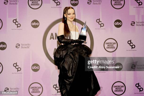 Dove Cameron, winner of the New Artist of the Year award, poses in the press room during the 2022 American Music Awards at Microsoft Theater on...