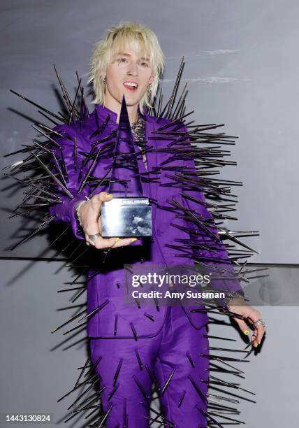 Machine Gun Kelly, winner of the Favorite Rock Artist award, poses in the press room during the 2022 American Music Awards at Microsoft Theater on...