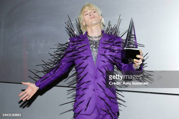 Machine Gun Kelly, winner of the Favorite Rock Artist award, poses in the press room during the 2022 American Music Awards at Microsoft Theater on...