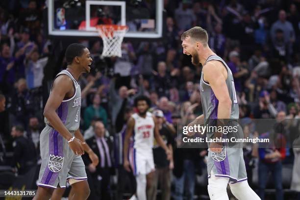 De'Aaron Fox and Domantas Sabonis of the Sacramento Kings celebrate after a three-point basket in the fourth quarter against the Detroit Pistons at...